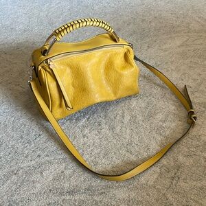 Mustard yellow slouch bag. Two separate zipper sections with inner pockets.
